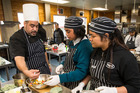 Hospitality tutor Karl Brown gives a lesson on fruit salad, with Southern Cross students Luisa Pulu, 16, left, and Bettina Adriano, 17. Photo/Jason Oxenham