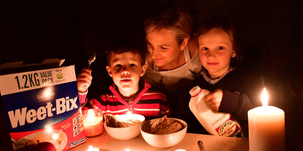 Dinner by candle light: A South Australia family dealing with the state-wide power outage. Photo / Keryn Stevens