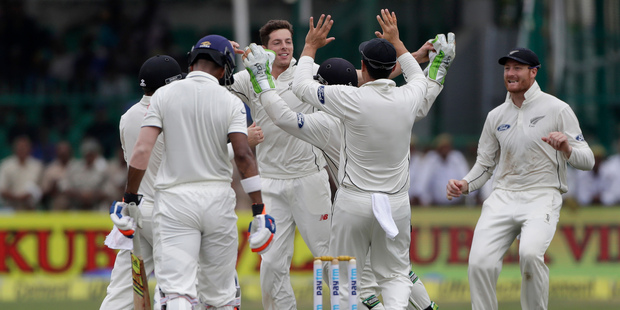 New Zealand team celebrates the wicket of India's Lokesh Rahul during first their first cricket test in Kanpur, India. Photo / AP