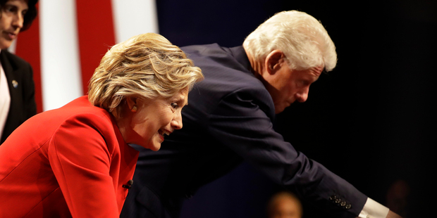 Hillary Clinton shakes hands with her husband Bill Clinton and audience members after the presidential debate. Photo / AP