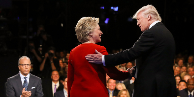 Hillary Clinton and Donald Trump shake hands as debate moderator Lester Holt looks on. Photo / AP