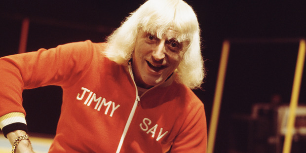 English disc jockey Jimmy Savile presenting the BBC music chart show 'Top Of The Pops', UK, circa 1973. Photo / Getty