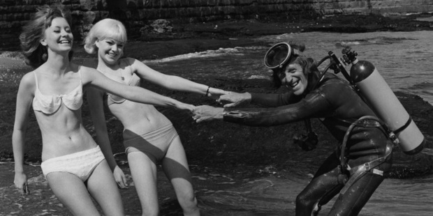 English disc jockey and TV presenter Jimmy Savile with his secretaries, Barbara Counsel (left) and Christine McCarthy, on the beach at Scarborough, Yorkshire, September 1966. Photo / Getty