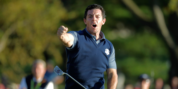 Europe's Rory McIlroy reacts after making his putt to win his match 3; 2 during a four-balls match at the Ryder Cup golf tournament Friday. Photo / AP.