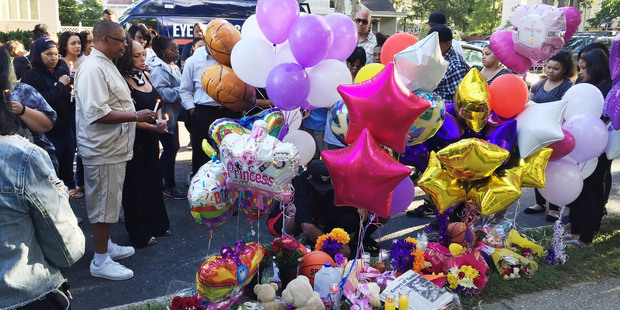 Family members, friends and community members gather for a vigil in Brentwood, N.Y. at a memorial near the scene where Nisa Mickens and Kayla Cuevas were found dead. Photo / AP