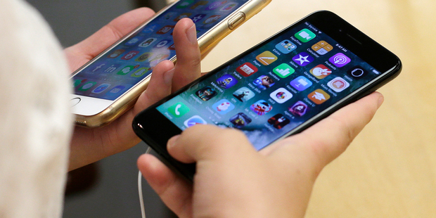 A new jet black iPhone 7 next to an iPhone 6 at an Apple Store. Photo / AP