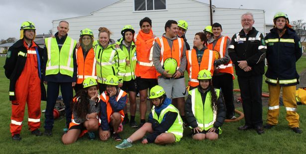 Dannevirke Cactus students, with Senior Constable Wayne Churchouse (second from left) and Paddy Driver, the Tararua District resilience manager, during their fire-fighting exercises at the Domain last Monday afternoon. Photo / Christine McKay