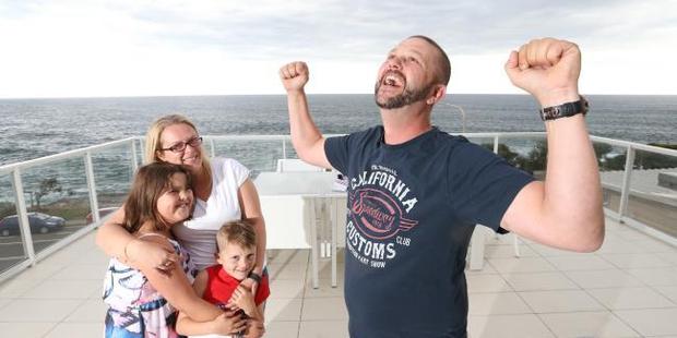 James Burry with wife Stephanie and children Jess and Mitchell at the oceanfront house they won in Freshwater. Photo / News Corp / Adam Taylor