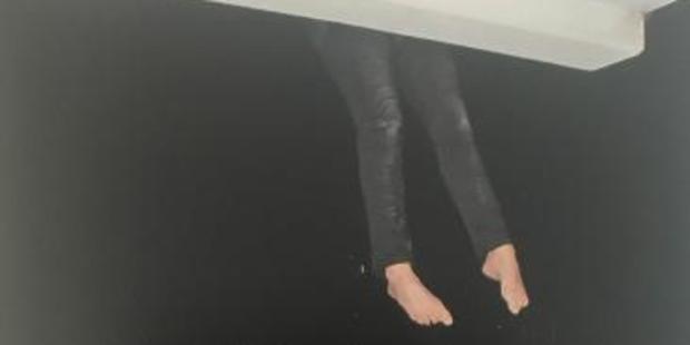 A police re-enactment of the scene below Tostee's apartment as Ms Wright tries to climb down. Photo / Supplied