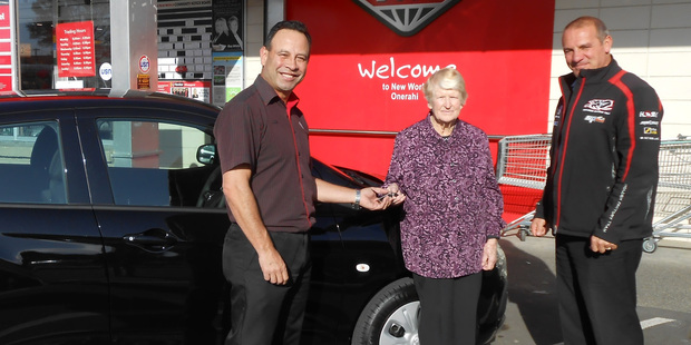 Nancy Sjoberg receives the keys to her new Holden LS Spark 1.4L auto from New World owner operator Peter Tuisaula (left) and James Ostle, from Mark Cromie Holden.