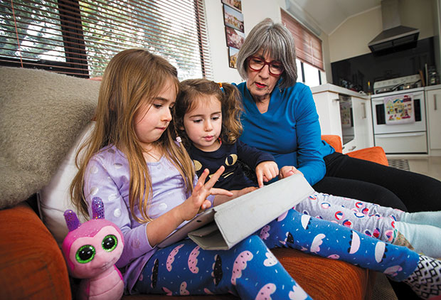 "It's hard to say no," says Anna John of granddaughters Clementine, 5, left, and Estelle, 3, using the iPad. Photo / Jason Oxenham