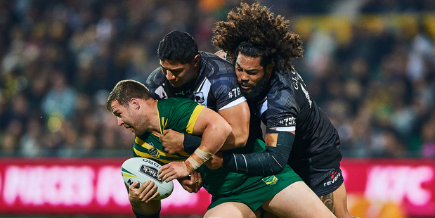 Trent Merrin of the Kangaroos is taken to the ground by Jason Taumalolo (left) and Adam Blair of the Kiwis. Photo / Photosport