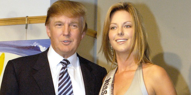 Donald Trump and Miss Universe Jennifer Hawkins pose for photographers at a cocktail party celebrating her crowning on July 28, 2004 in New York City. Photo / Getty