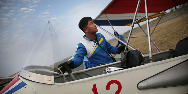 North Korean pilot Mun Jong Hun performs flight checks before flying his ultralight aircraft over Pyongyang. Photo / AP