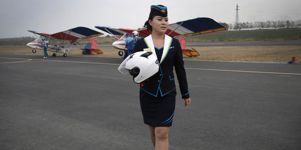 A staff member of the Mirim Air Club walks across the tarmac. Photo / AP