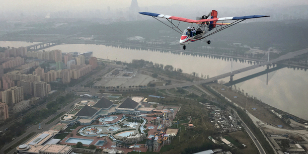 An ultralight aircraft flies over Pyongyang. Photo / AP