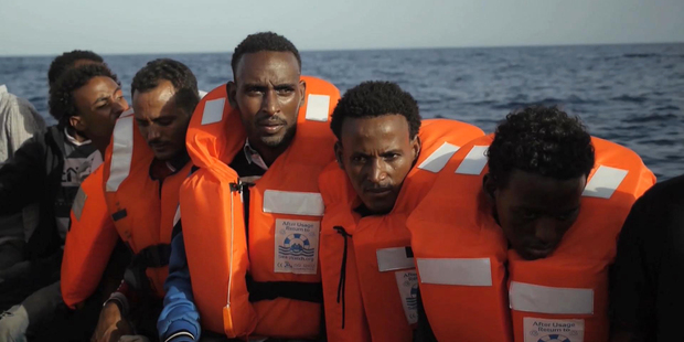A rescue boat is filled with migrants taken from a vessel in the Mediterranean Sea off the coast of Libya. Photo / AP