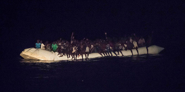 Refugees sit in a inflatable boat off the Libyan coast in the Mediterranean Sea. Photo / AP