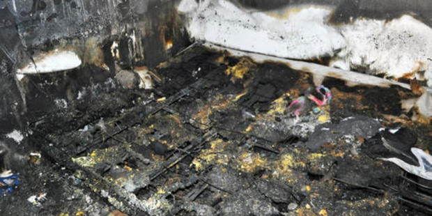 This photo provided by the Spokane Fire Department shows the bed where a toddler and his dog died in a fire. Photo / AP