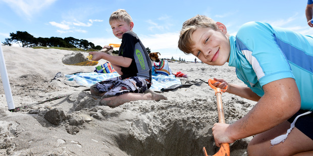 Liam, 9, and Aiden Louw, 6, enjoy the sunny weekend on the beach at Papamoa Domain. Photo/George Novak