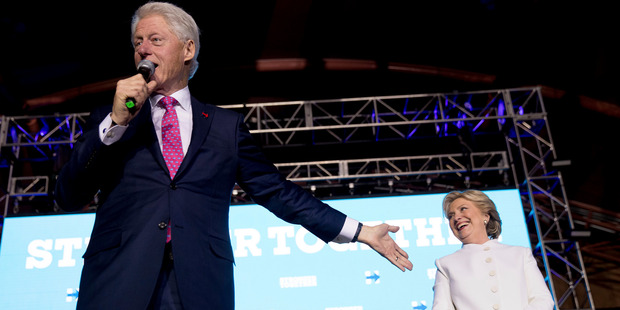 Former President Bill Clinton, left, accompanied by Democratic presidential candidate Hillary Clinton. Photo / AP