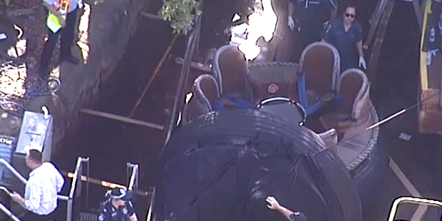Rescue personnel stand by the Thunder River Rapids ride at Dreamworld on the Gold Coast. Photo / Channel 9 via AP