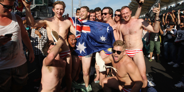 Australian mates the Budgie Nine were facing jail time for stripping to their budgie-smugglers, Malaysian flag on the back, at the Grand Prix. Photo / AP