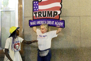 Anti-Trump protester Loris Jones-Randolph, 27, and Trump supporter Elena Rubak, 52, discuss their differences outside Trump Tower.