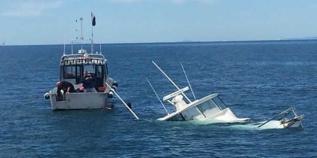 A boat is being salvaged near Rakino Island after its crew abandoned the sinking vessel this morning. Photo / Kim Francis