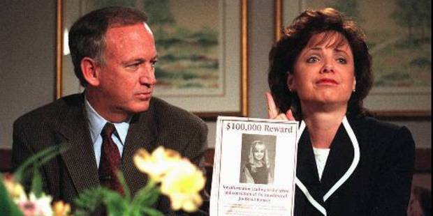 John and Patsy Ramsey hold up a poster for information on who murdered their 6-year-old daughter. Photo / AP