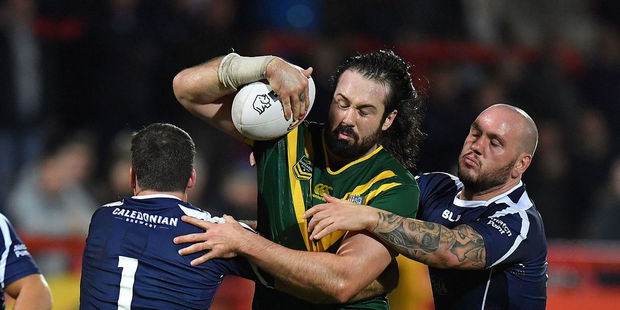 Australia's Aaron Woods looks to evade the tackles of Lachlan Coote and Dale Ferguson in the Kangaroos' recent 54-12 win over Scotland in Hull. Photo / Photosport