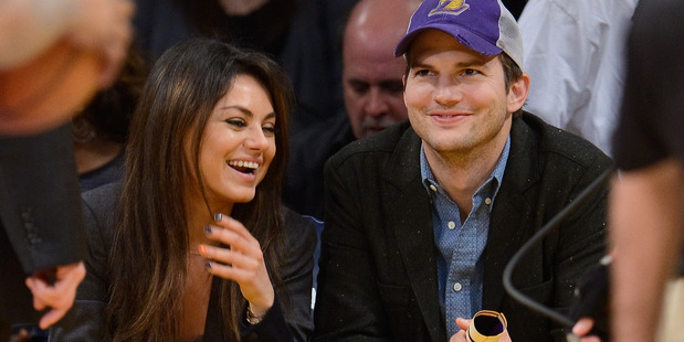 Ashton Kutcher (R) and Mila Kunis attend a basketball game between the Utah Jazz and the Los Angeles Lakers at Staples Center on January 3, 2014. Photo / Getty
