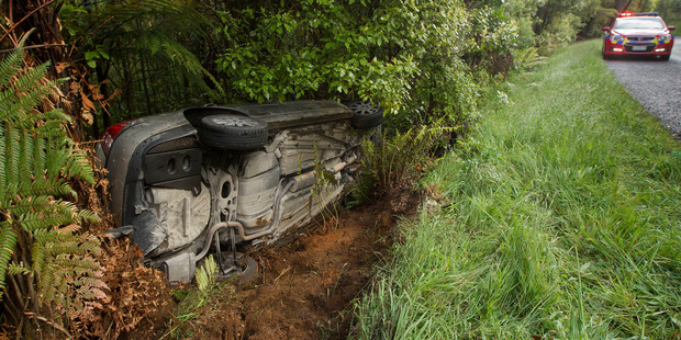 Three young men escaped injury when their car went off the road about three-quarters of the way up Mountain Rd this evening. Photo/Ben Fraser