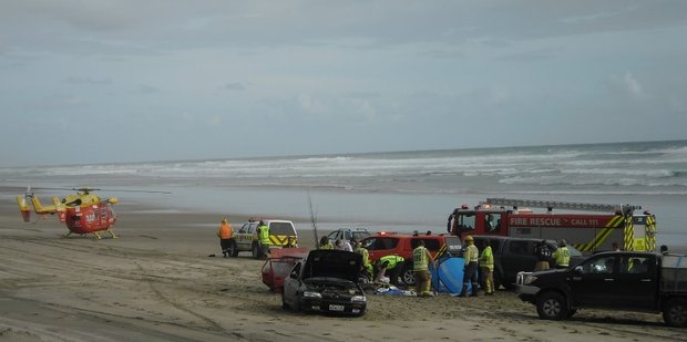 Paramedics attend to injured motorists on Baylys Beach after a two-car crash on Saturday.