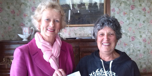 Bushy Park Sanctuary chairwoman Liz Tennet (left) receives a cheque from Forest & Bird Wanganui branch chairwoman Esther Williams. PHOTO/ SUPPLIED