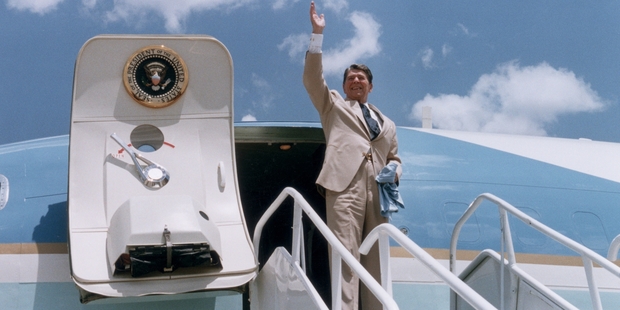 10th July 1986: US President Ronald Reagan waves as he stands at the top of a stairway, preparing to board Air Force One, Dothan, Alabama. Photo / Getty