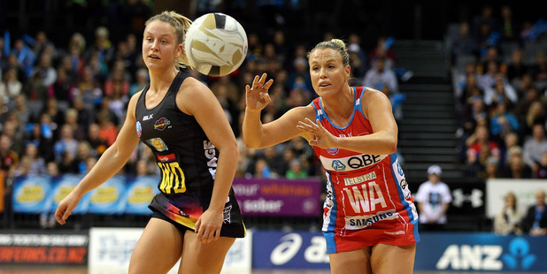 Swifts' Kimberlee Green passes with Magic's Jamie-Lee Price chasing during the ANZ Championship semi-final. Photo / Getty Images