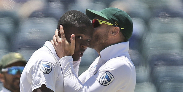 South Africa's captain Faf du Plessis, right, kisses Kagiso Rabada on the top of the head after he took the wicket of Australia's Mitchell Starc. Photo / AP