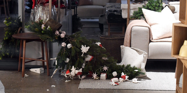 A christmas tree lies on its side in a shop in Wellington after an earthquake. Photo / EPA
