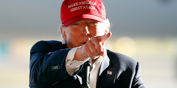 If Trump carries out his trade and defence threats, NZ would face the risk of slower global economic growth, higher interest rates and fewer capital flows, writes Hickey. Photo / AP