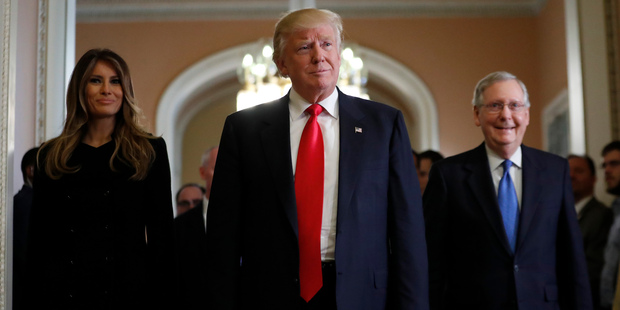 President-elect Donald Trump and his wife Melania walk with Senate Majority Leader Mitch McConnell at the White House last week. Photo / AP