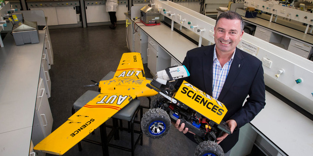 Professor of Applied Ecology Steve Pointing with a Mars rover and remote plane used in Antarctica. Photo / Jason Oxenham
