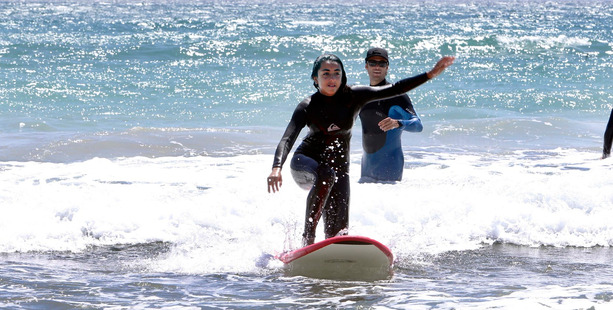 A planned surf lesson for a group of international students at Sandy Bay went ahead yesterday after advice from Civil Defence. PHOTO/JOHN STONE