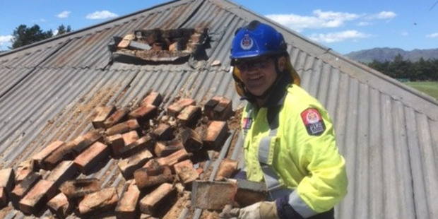On the ground: Mike Adams, a member of the Culverden Volunteer Fire Brigade, fixing chimneys at the epicentre of the 7.5 magnitude earthquake which struck on Monday morning. Photo/supplied.
