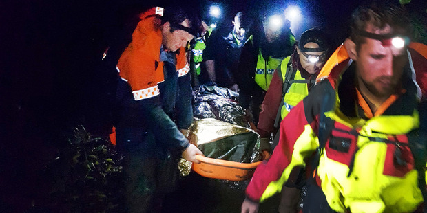 The injured tramper on the Te Araroa Trail is carried down a creek on Tuesday evening. It took rescuers four hours to bring him to a waiting ambulance.