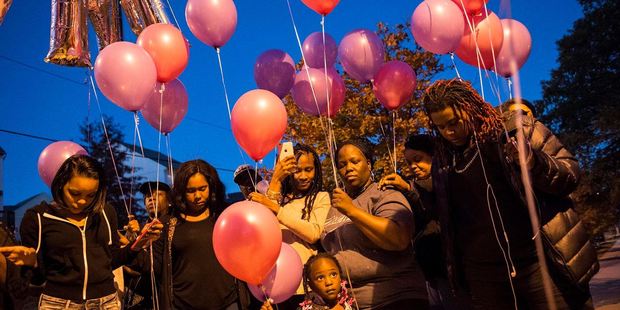 Family members and friends gather in November in Northeast Washington for a prayer and balloon release in remembrance of LaKira's twin daughters. Photo: Nikki Kahn, The Washington Post.