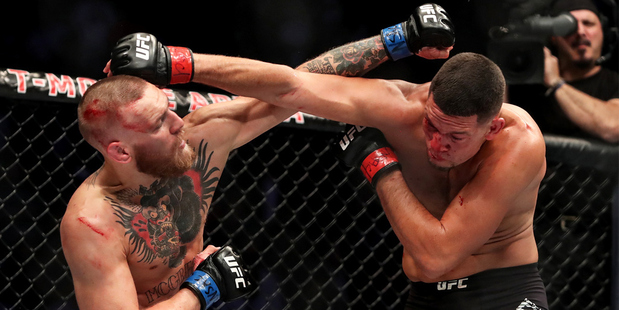 Conor McGregor and Nate Diaz throw misfiring punches at each other. Photo / Photosport