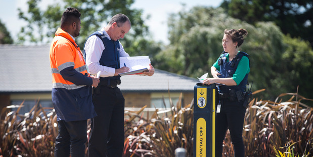 Police and security at the Ranui train station. Photo / NZ Herald