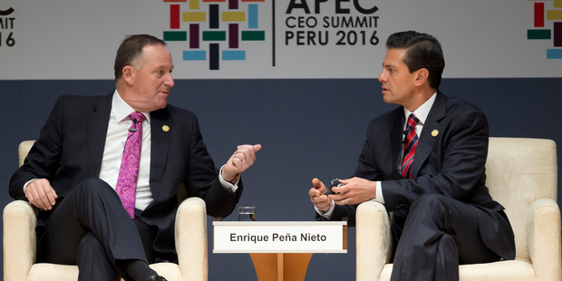 PM John Key talks to Mexican President Enrique Pena Nieto yesterday during a forum about trade at the APEC CEO Summit in Lima, Peru. Photo / AP