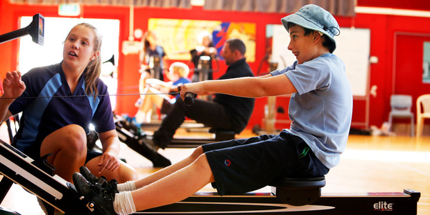 Cailee Bowmar urges on fellow student Josh Dawson at the beginning of Whangarei Intermediate School's 24 hour row for charity. Photo / John Stone